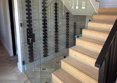 Frameless glass balustrade installed alongside a modern timber staircase
