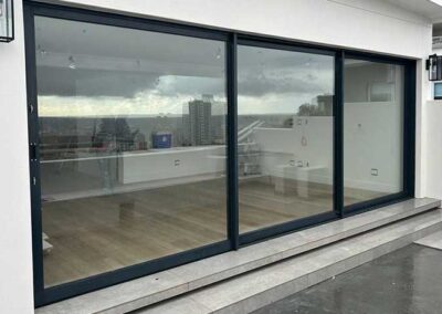 Black-framed sliding glass doors spanning a wide modern residential opening